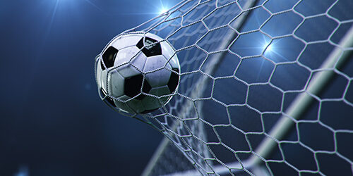 Soccer ball flew into the goal. Soccer ball bends the net, against the background of flashes of light. Soccer ball in goal net on blue background. A moment of delight, 3D illustration